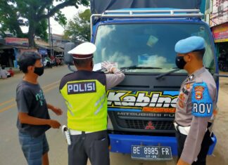 Personel Satlantas Polres Tulang Bawang sedang memasang stiker pada kendaraan truck saat menggelar Operasi Zebra Krakatau-2020